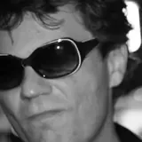 Dan Metille in sunglasses, photographed in black and white.